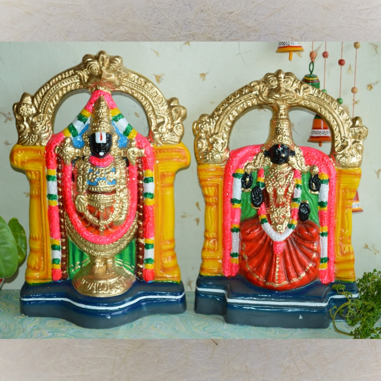 Handcrafted Navarathri Golu dolls of Lord Perumal and Goddess Thaayar adorned with vibrant garlands and intricate arches.