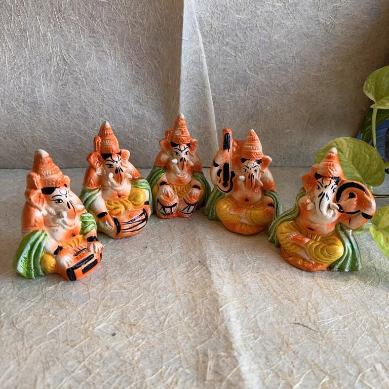 Handcrafted Navarathri Golu Ganesh Musical Ensemble with five miniature figures of Lord Ganesha playing Tabla, Veena, Mridangam, Harmonium, and Flute.