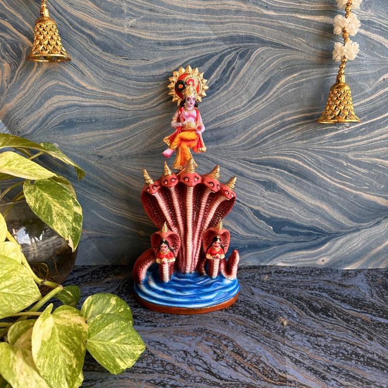 Handcrafted Krishna Kalinganarthana Golu doll featuring Lord Krishna dancing on the serpent Kaliya, surrounded by a detailed, vibrant background.