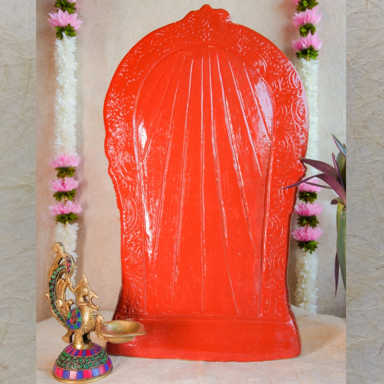 Handcrafted Navarathri Golu doll of Goddess Abirami adorned in a vibrant red saree with intricate jewelry, set within a decorative arch.