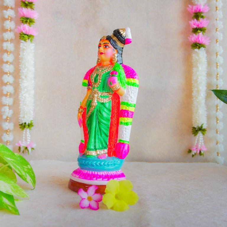 Hand-painted Navarathri Golu Doll of Andal, adorned in a green saree and colorful garlands, symbolizing divine grace and devotion.