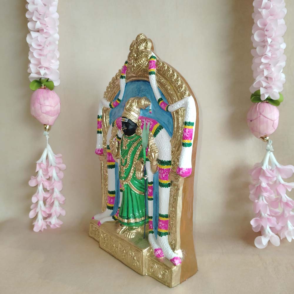 Handcrafted Abirami idol with intricate detailing, adorned with vibrant colors and floral garlands.