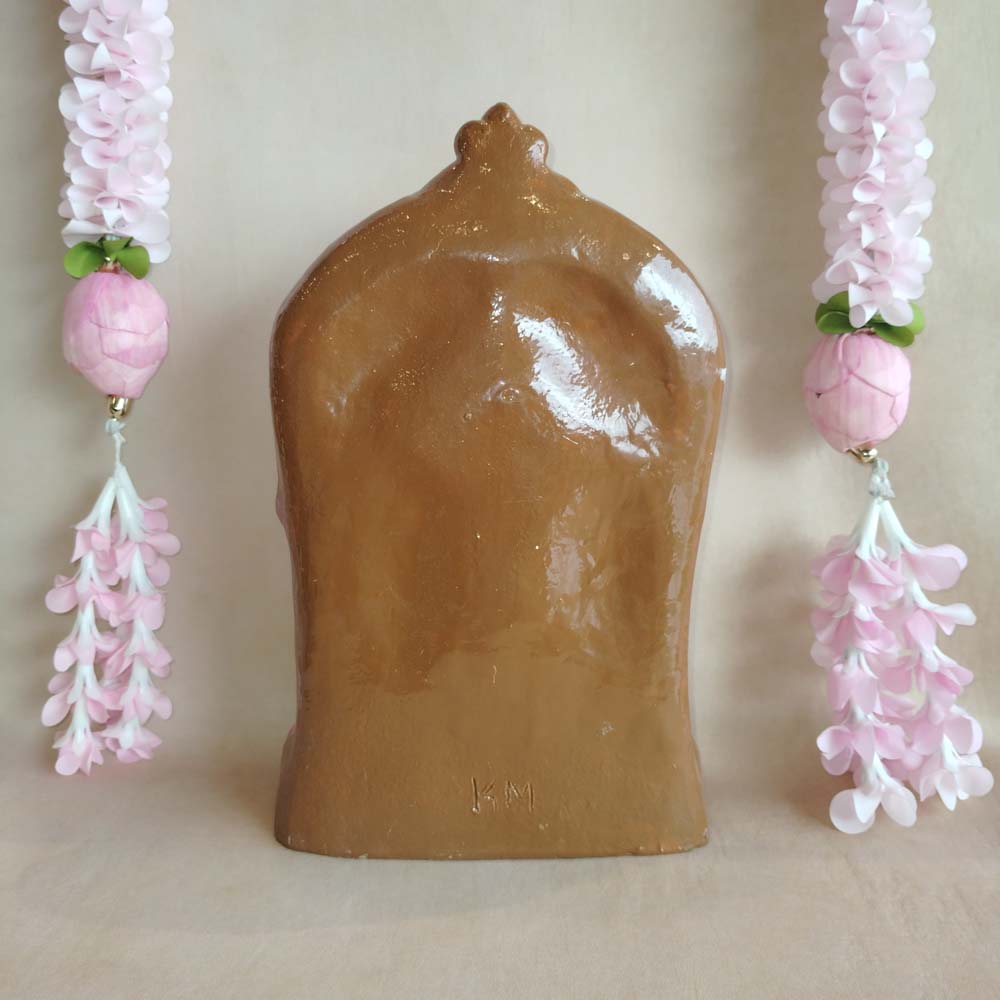 Handcrafted Abirami idol with intricate detailing, adorned with vibrant colors and floral garlands.