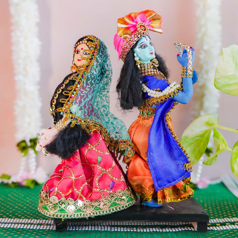 Handcrafted Radha Krishna dolls with Krishna playing the flute and Radha in a graceful pose, dressed in vibrant traditional attire with intricate details.