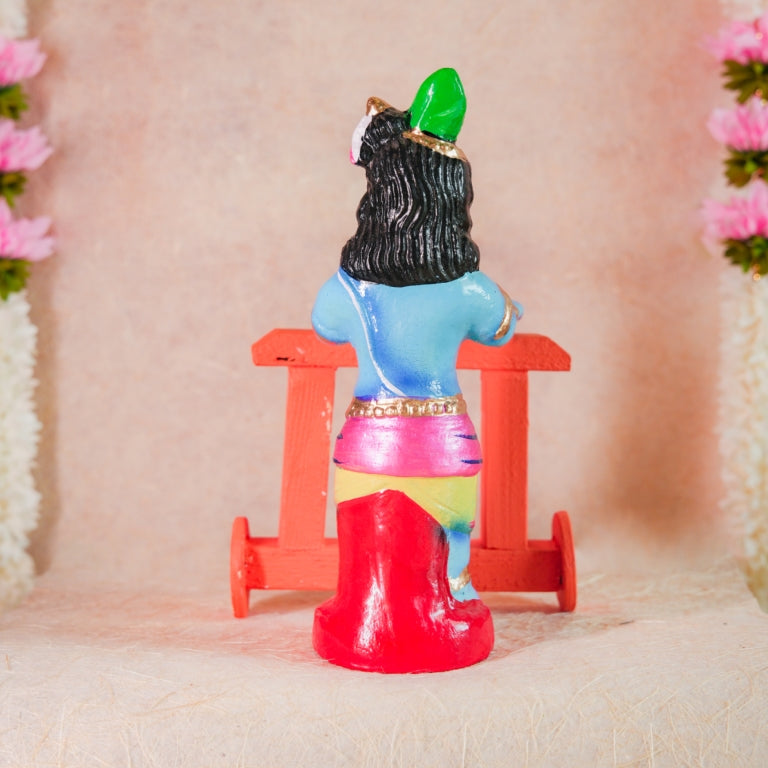 Handcrafted Nadaivandi Krishna idol featuring baby Krishna in blue with traditional ornaments riding a walker for Navaratri Golu.