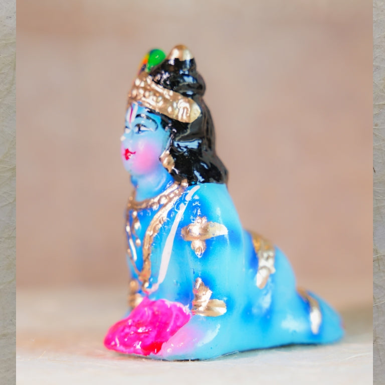 Handcrafted Navarathri Golu doll - Baby Krishna crawling with intricate jewelry and vibrant colors.
