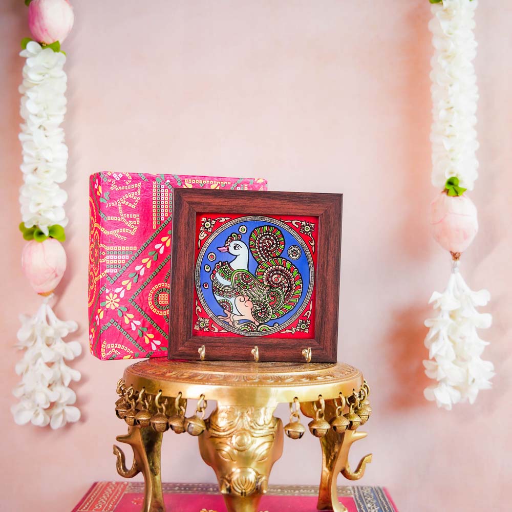 Decorative keyholder featuring a hand-painted Annam (mythical swan) medallion design in vibrant colors, framed with dark wood, and equipped with key hooks.