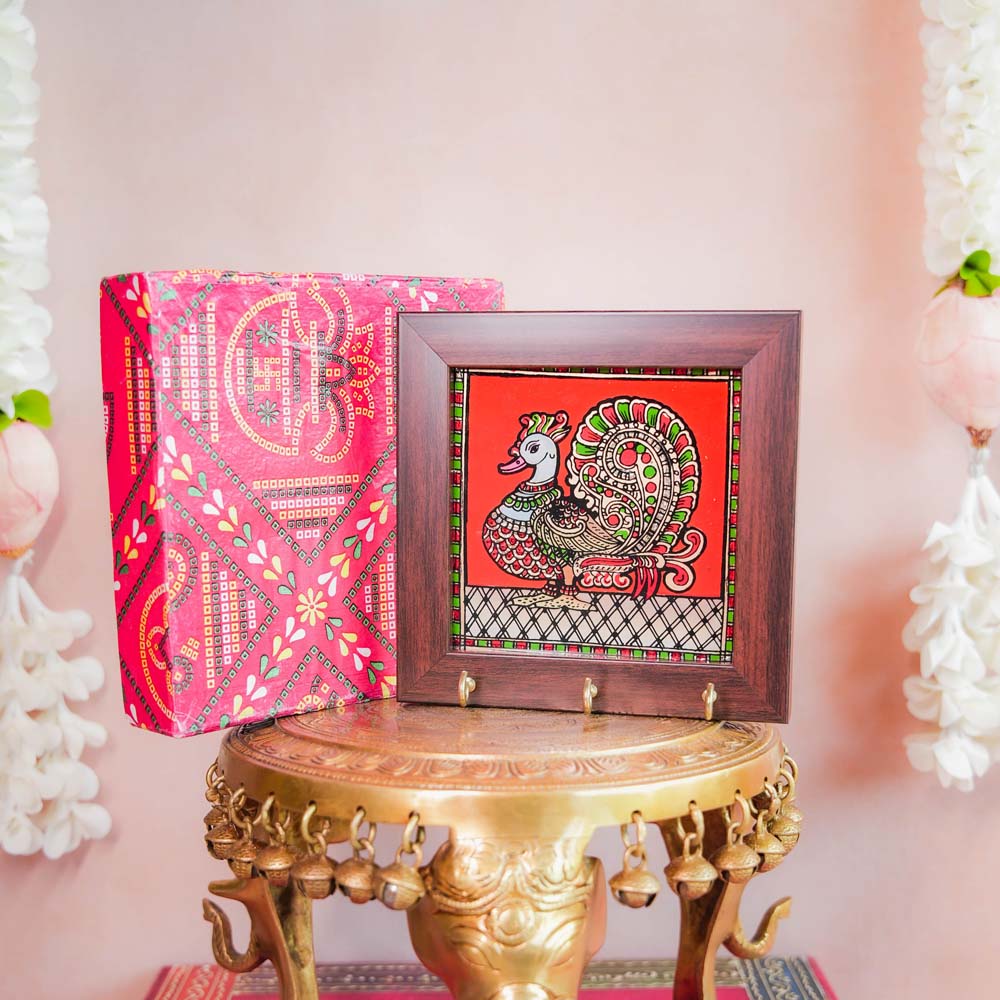 Decorative keyholder featuring a hand-painted Annam (mythical swan) design on a vibrant Red background, framed with dark wood, and equipped with key hooks.