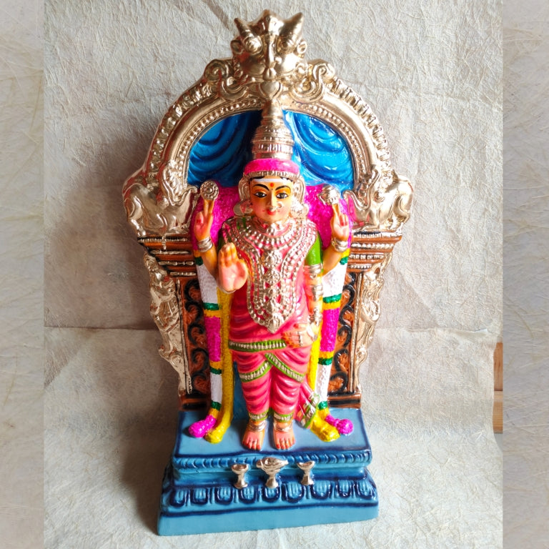 Handcrafted Navarathri Golu doll of Abayambigai Amman, adorned in a green saree with traditional jewelry, set under a golden arch with intricate detailing.