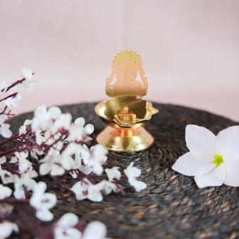 Gold Finish Ganesh Lamp with Intricate Design of Lord Ganesha Seated on a Pedestal.