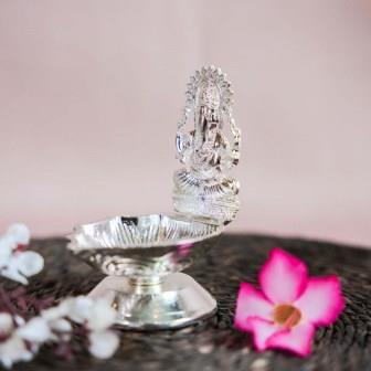 Silver Finish Ganesh Lamp with Intricate Design of Lord Ganesha Seated on a Pedestal.