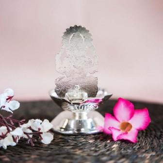 Silver Finish Ganesh Lamp with Intricate Design of Lord Ganesha Seated on a Pedestal.