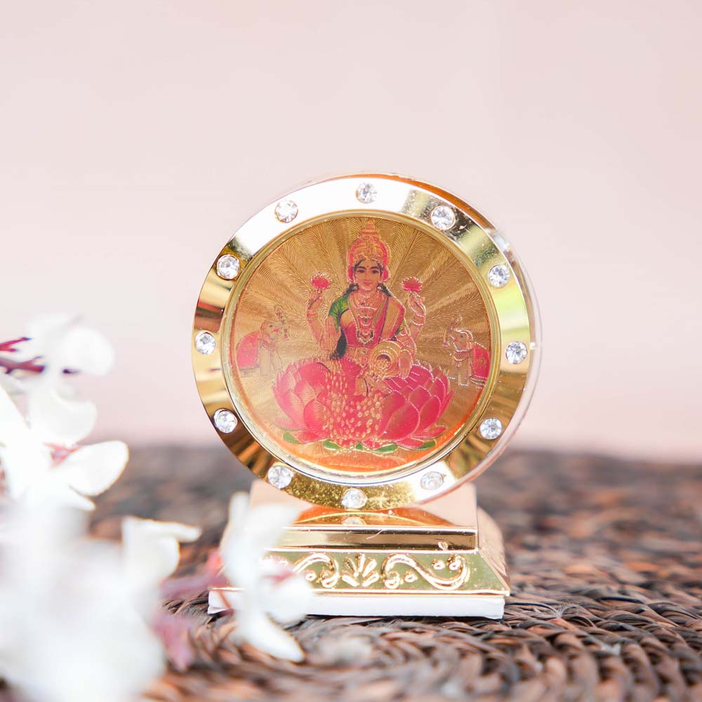 Golden Lakshmi Car Dashboard Stand with Embedded Crystals and Lotus Design.