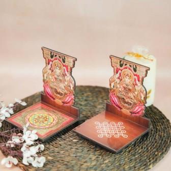 Gajalakshmi Diya Wall Stand featuring Goddess Gajalakshmi seated on a lotus with elephants, paired with a wooden base showcasing Sri Yantra and kolam designs.
