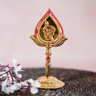 Gold-finish decor piece of Lord Murugan's face with Vel, featuring intricate detailing and vibrant accents.