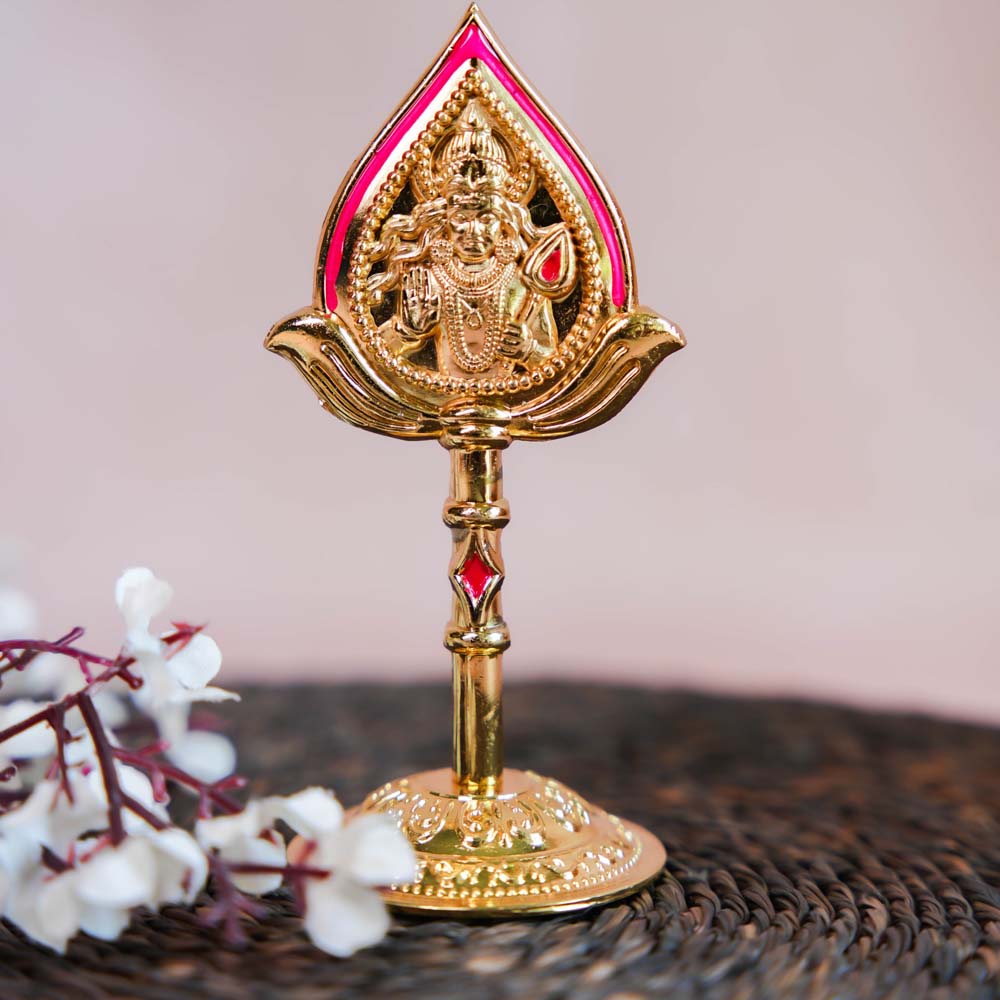 Gold-finish decor piece of Lord Murugan's face with Vel, featuring intricate detailing and vibrant accents.