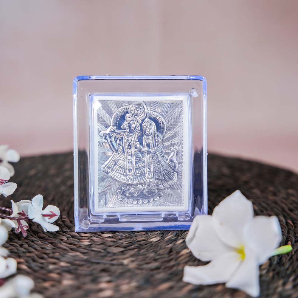 Silver Radha Krishna Frame in a Transparent Stand with Detailed Silver Depiction of Radha and Krishna.