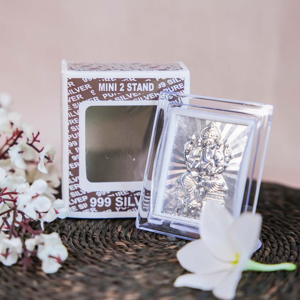 Silver Ganesh Frame in a Transparent Stand with Detailed Carving of Lord Ganesha.