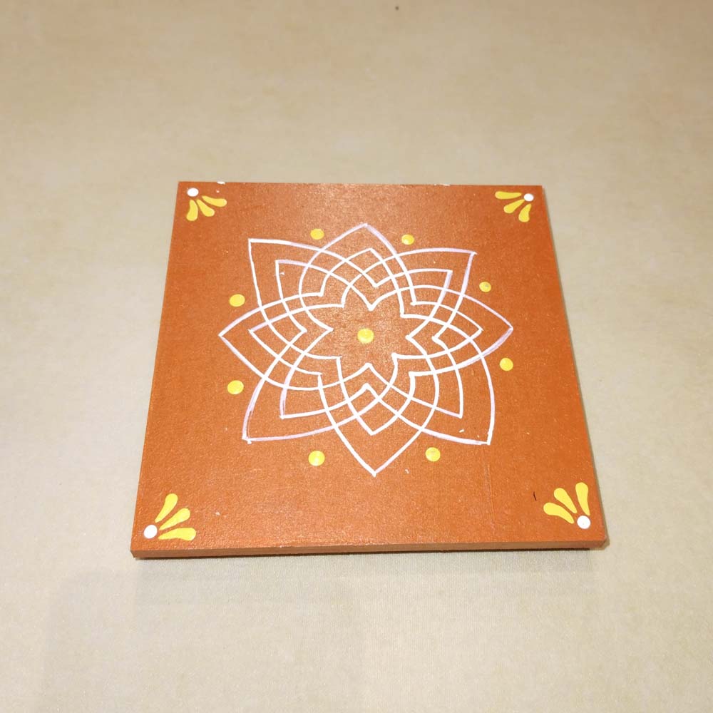Orange Kolam Manai platform with a red kolam design, used for traditional pooja and rituals.