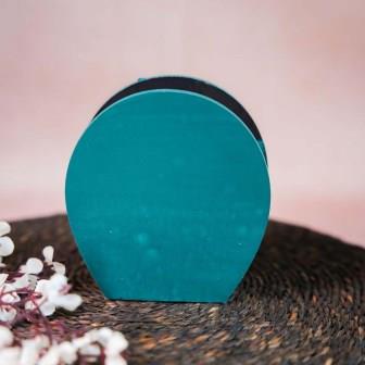 Hand-painted wooden penstand with a decorative elephant design in white and gold on a teal background.
