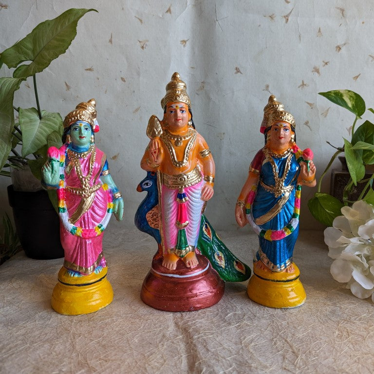 Handcrafted idol set of Lord Murugan with Valli and Devayani, adorned in vibrant traditional attire for Navaratri Golu.