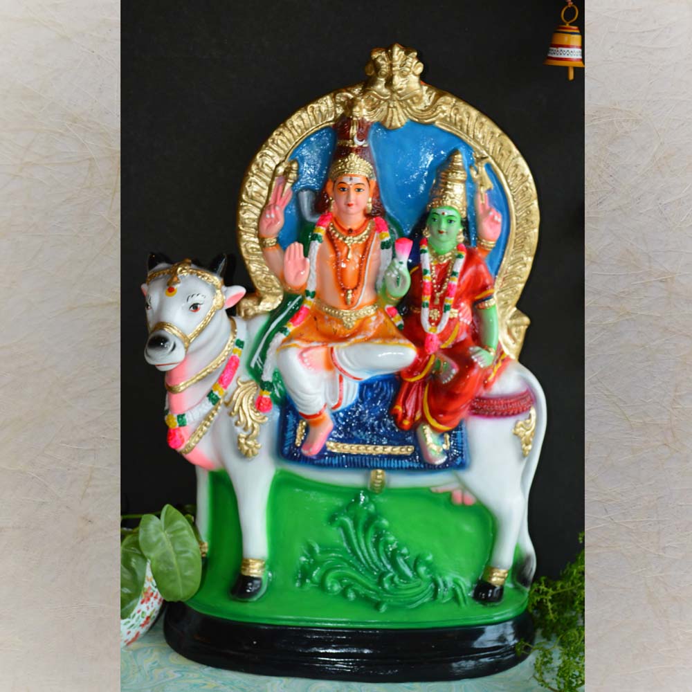 Handcrafted Navarathri Golu doll of Lord Shiva and Goddess Parvati seated on Nandi, adorned with intricate detailing.