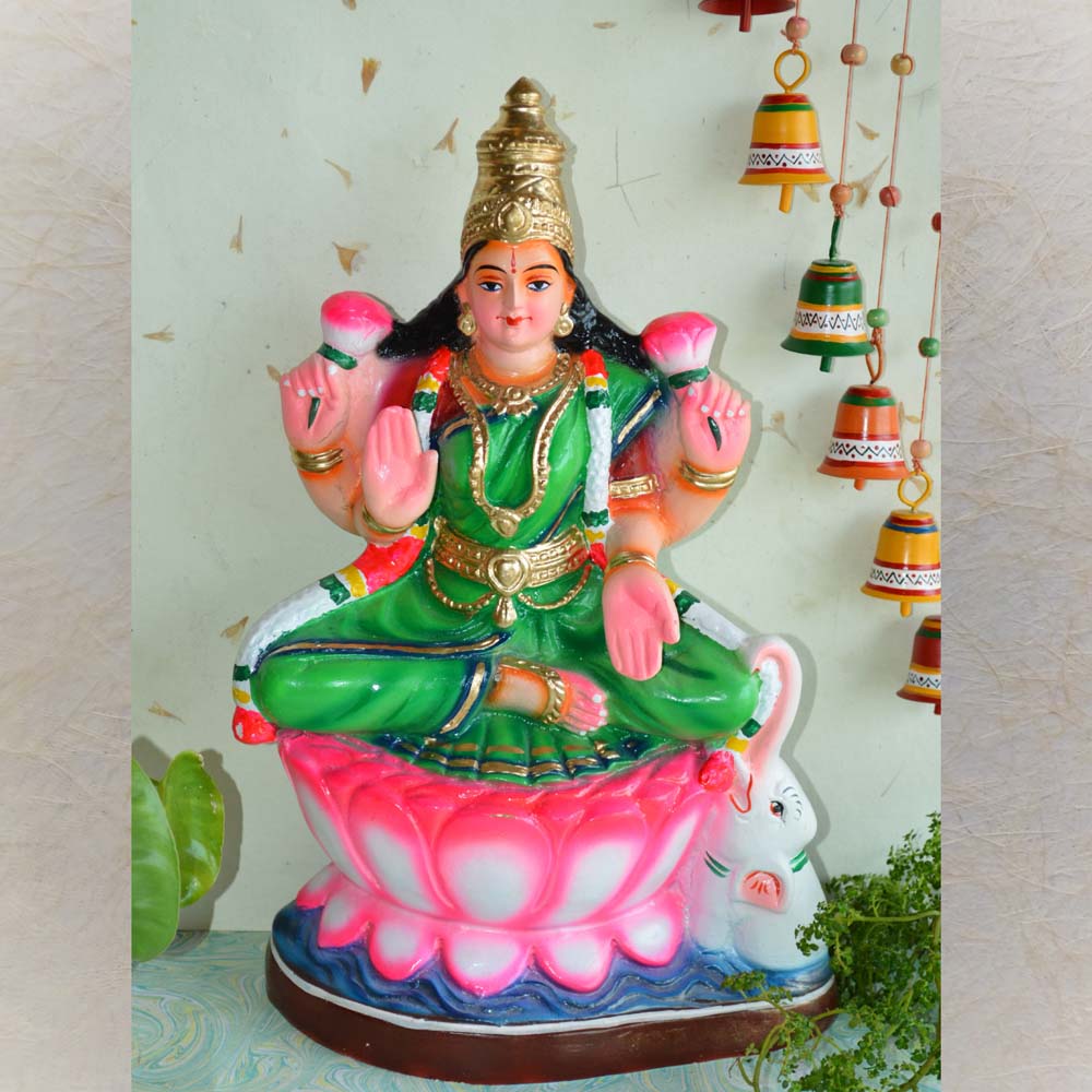 Handcrafted Navarathri Golu doll of Goddess Lakshmi seated on a lotus, holding lotus flowers in her hands.