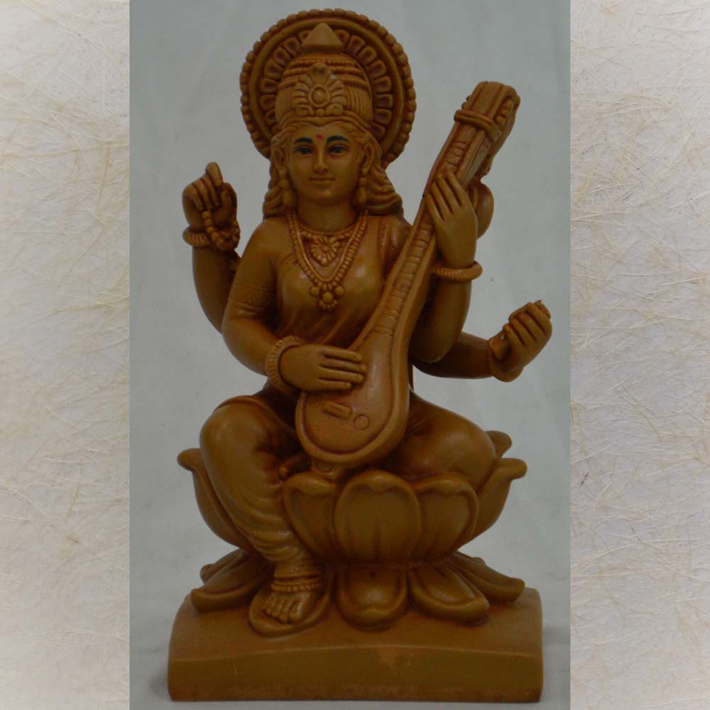 Enchanting Saraswathi idol seated on a lotus with a veena, intricately designed for pooja rituals and home decor.
