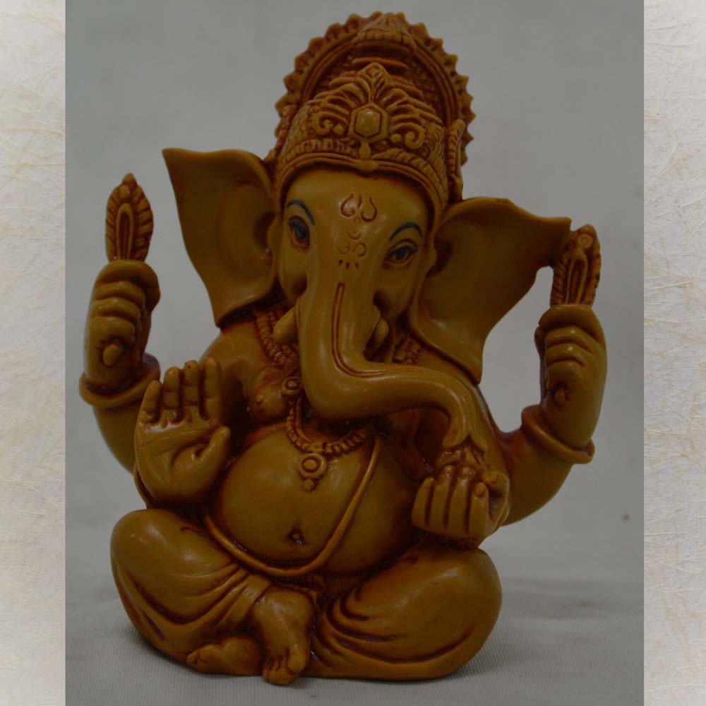 Detailed sitting Ganesh idol with intricate carvings, ideal for home décor and pooja rituals.