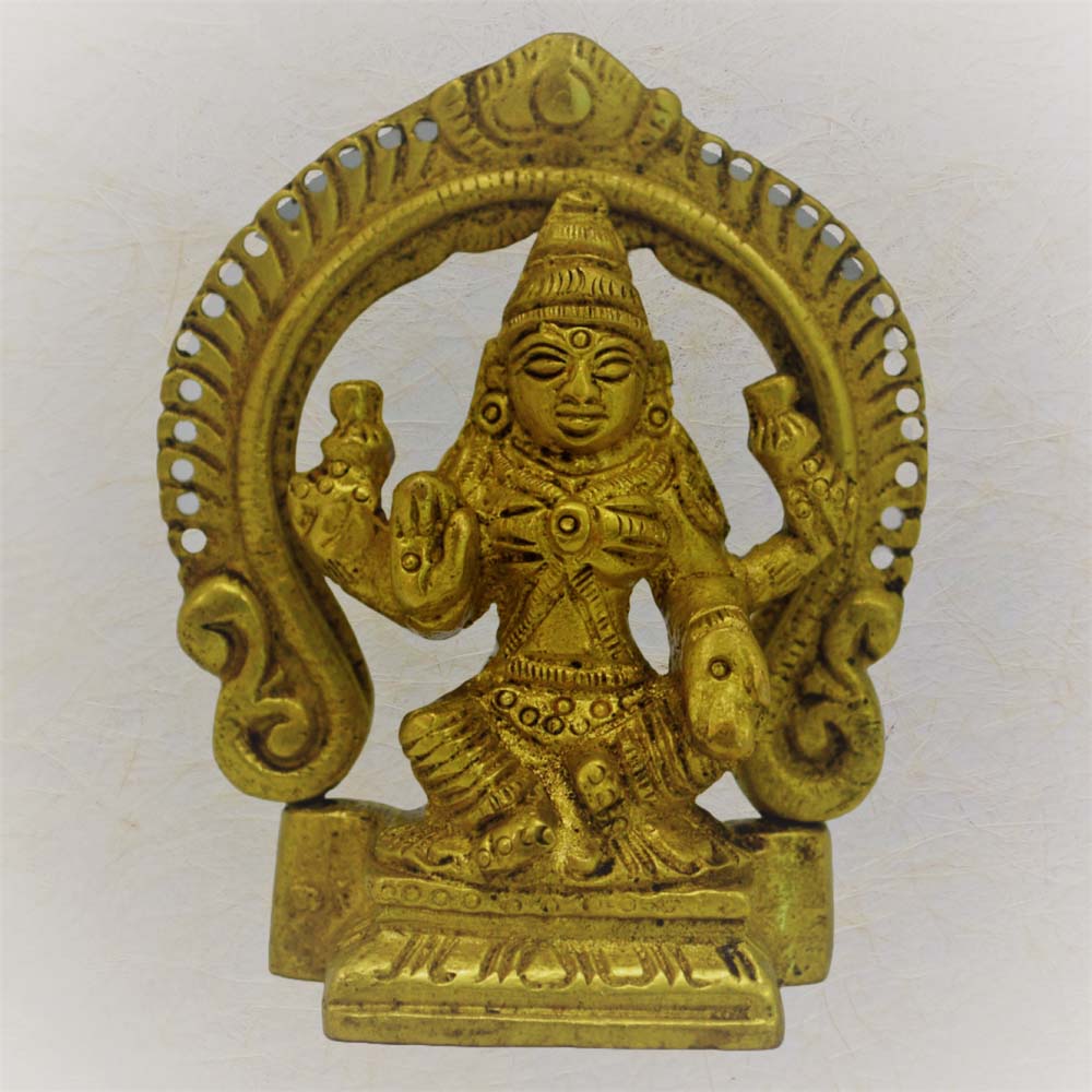 Handcrafted brass idol of Goddess Lakshmi seated under an ornate arch, symbolizing prosperity and grace.