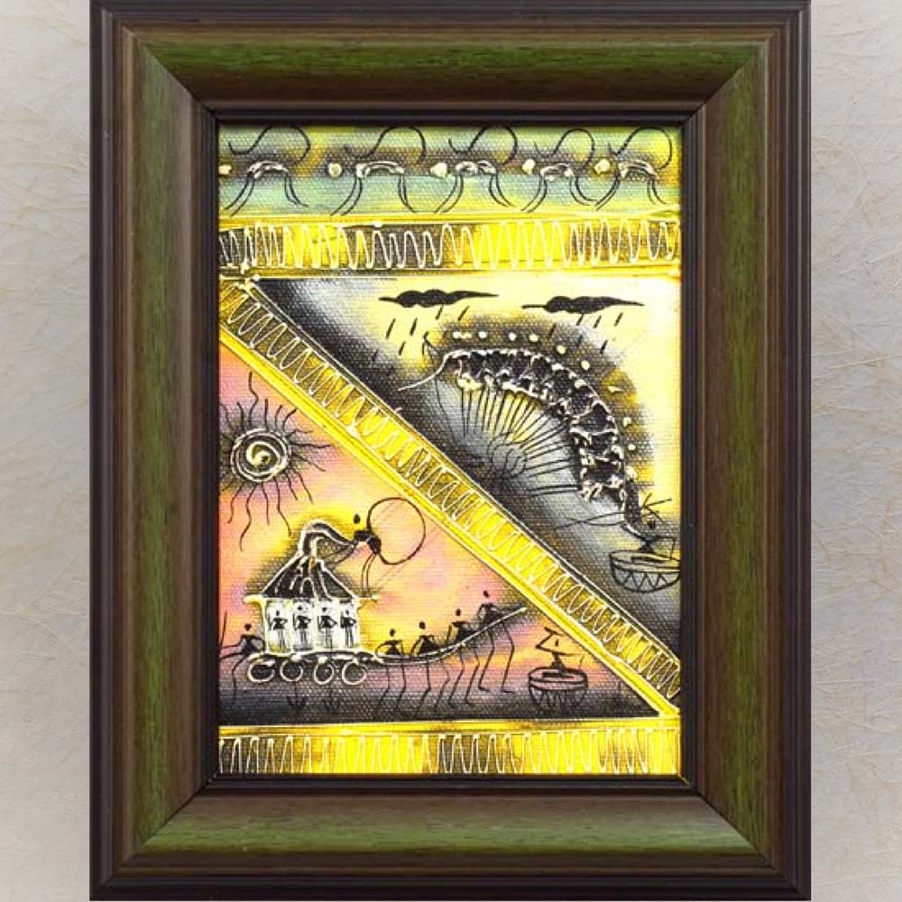 Framed Warli painting featuring a tribal celebration with dancing figures, a village procession, and nature motifs in gold, yellow, and black tones.