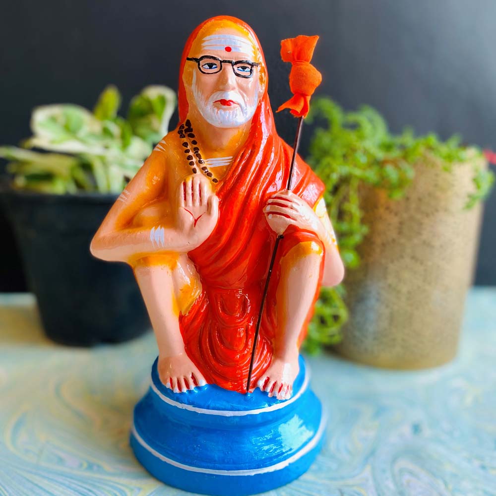 Handcrafted idol of Kanchi Periyava, a Hindu saint, featuring vibrant colors and intricate details, perfect for spiritual home décor.