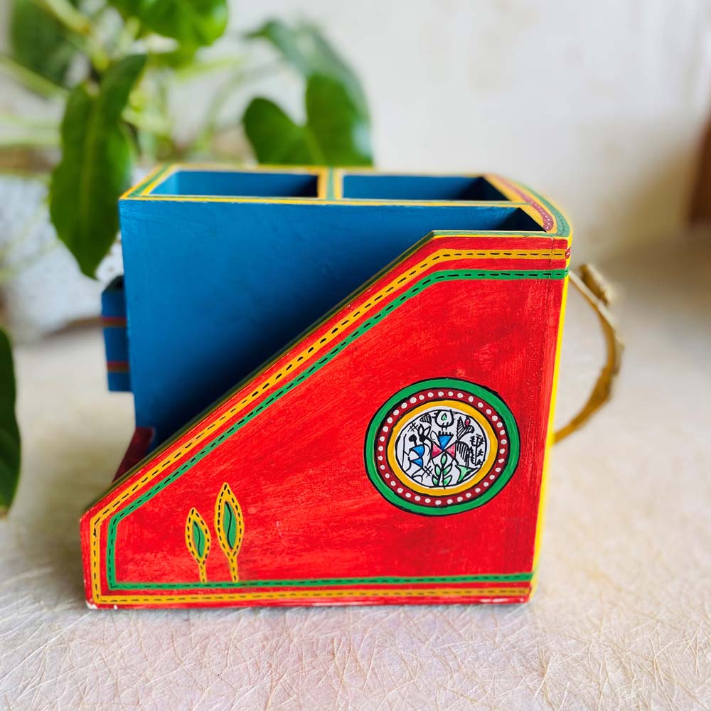 Handcrafted wooden cutlery holder with colorful hand-painted design and a Dhokra lady handle, featuring multiple compartments.