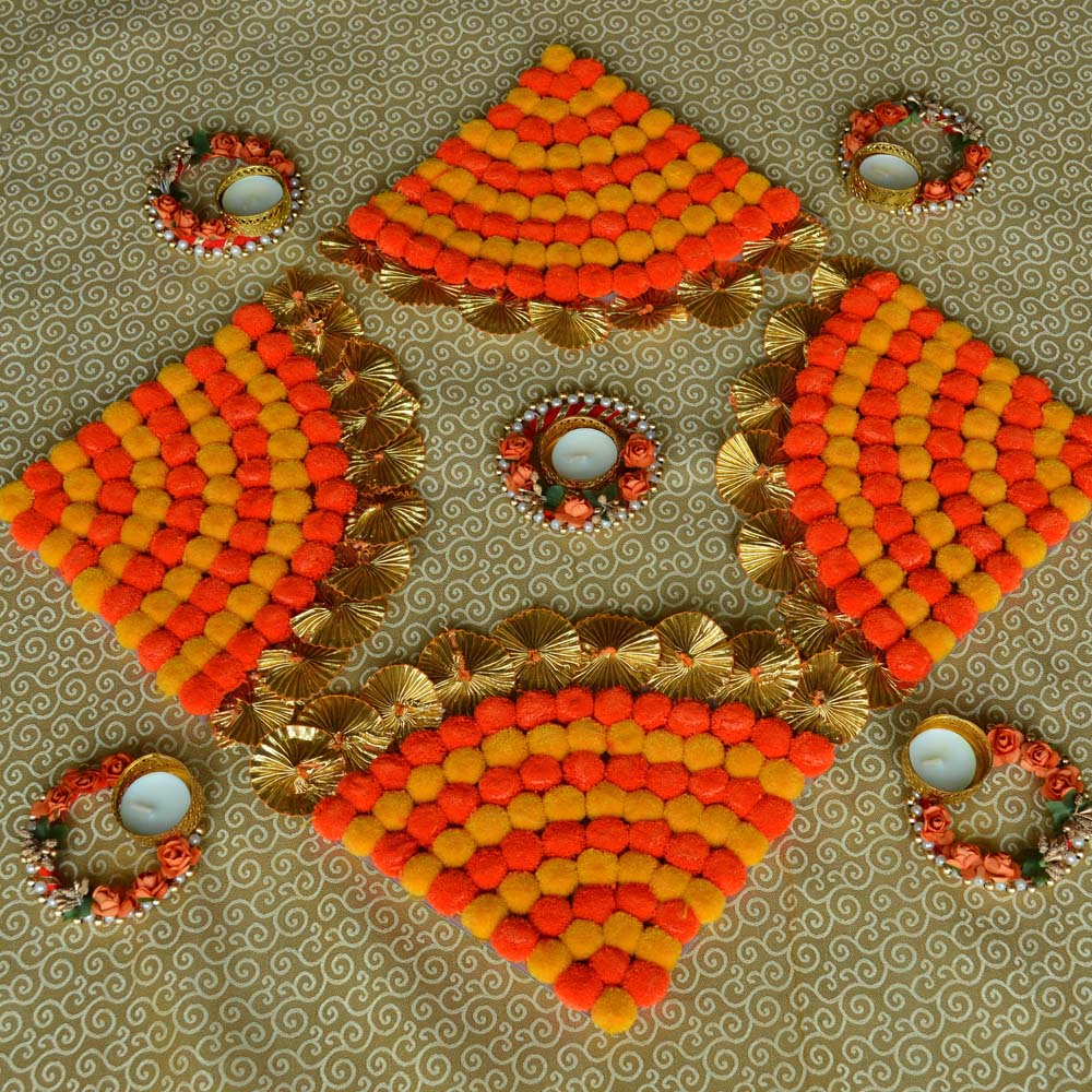 Auspicious Pom Pom Floor Decoration Set with orange and yellow pom-poms, golden accents, and floral T-light holders.