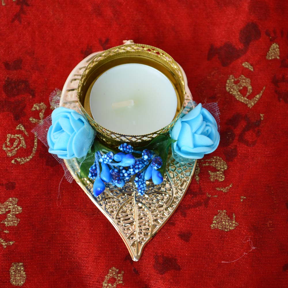 Fancy Leaf T-Light Diya with blue flowers and gold lattice holder on a golden leaf base.