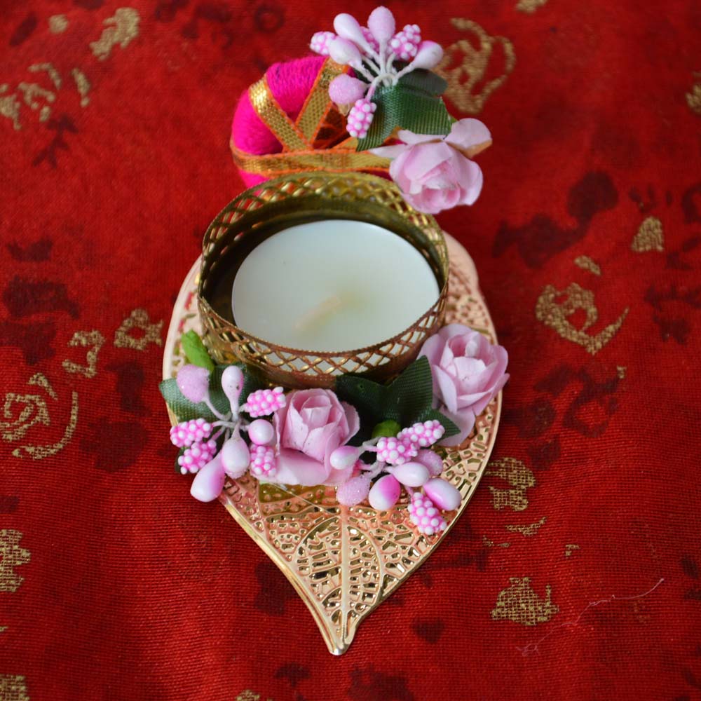 Fancy Leaf T-Light Diya with pink flowers and a gold lattice T-light holder on a golden leaf base.