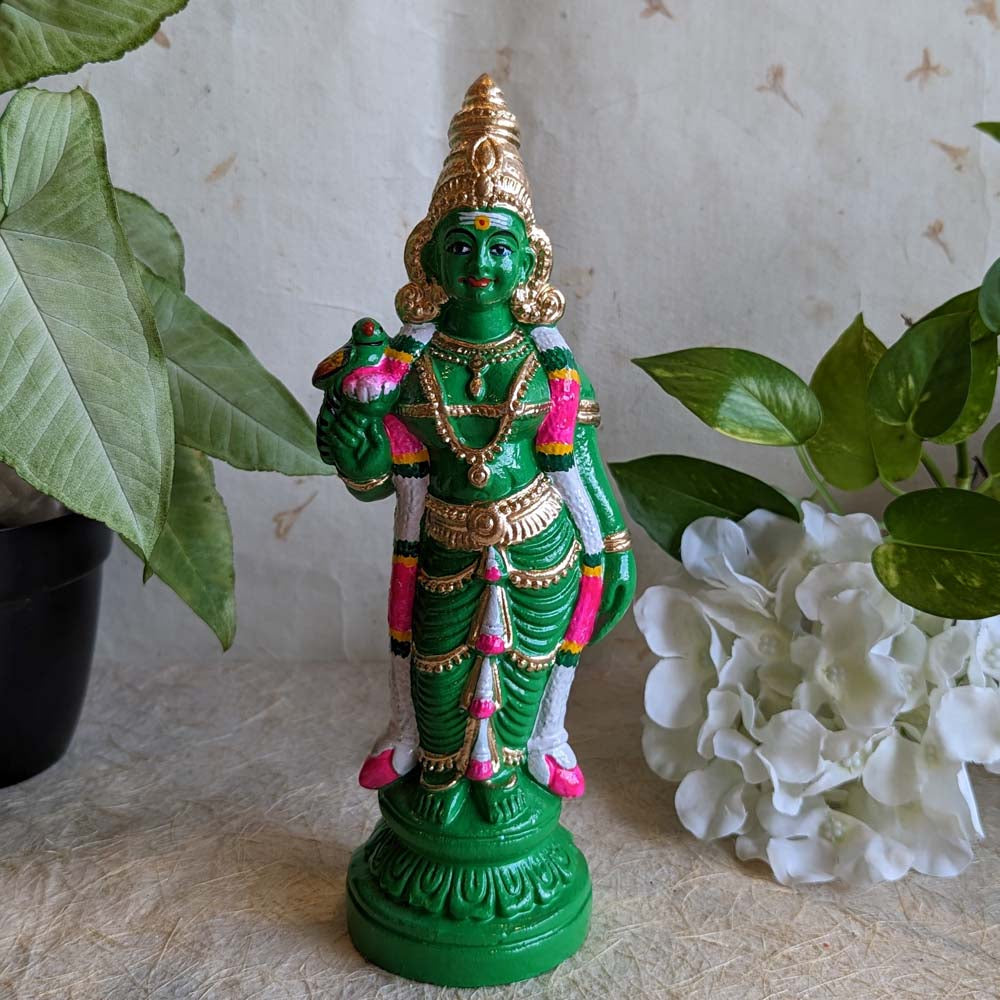 Hand-painted Goddess Meenakshi Golu doll in green attire, holding a parrot, adorned with intricate gold jewelry, perfect for Navaratri festival decor.