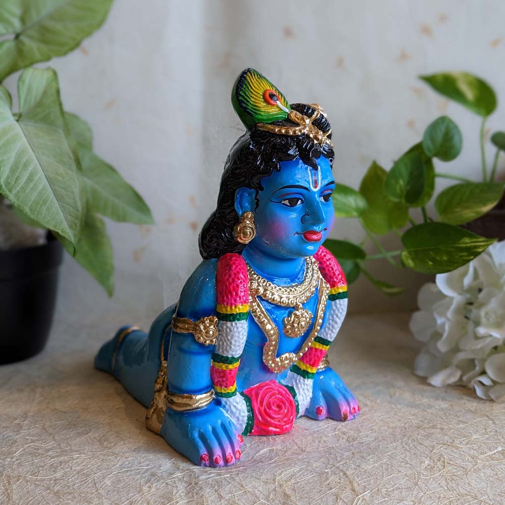 Hand-painted medium Crawling Krishna Golu doll (Thavazhum Kannan) in vibrant blue with peacock feather crown, ideal for Navarathri celebrations.