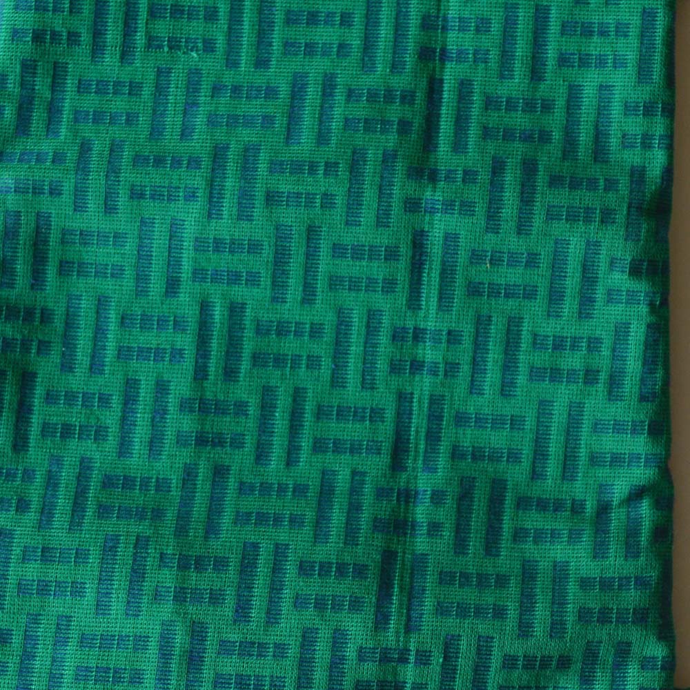 Green blouse fabric with woven geometric design, 80 cm length.