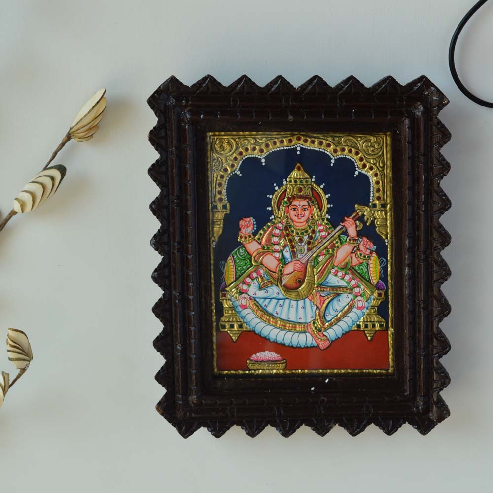 Bejeweled Tanjore Painting of Goddess Saraswathi Holding a Veena in a Carved Wooden Frame