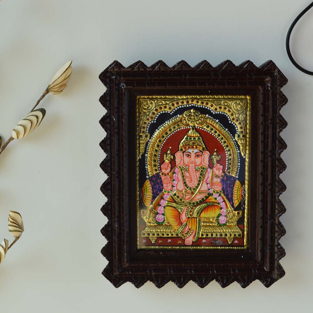 Bejeweled Tanjore Painting of Lord Ganesh in a Carved Wooden Frame with Gold Foil Detailing