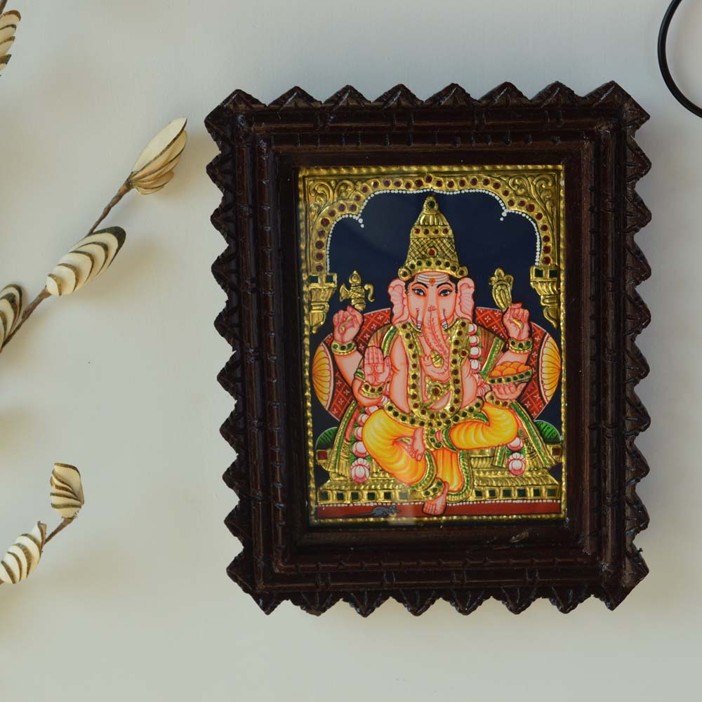 Bejeweled Tanjore Painting of Lord Ganesh in a Carved Wooden Frame with Gold Foil Detailing
