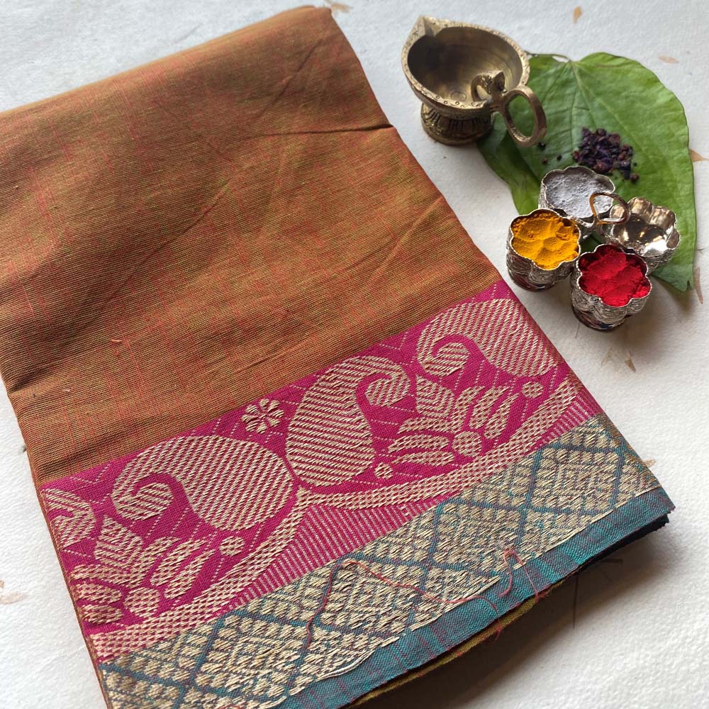 Elegant cotton fabric in rich red with a detailed traditional border, perfect for crafting and festive decorations.