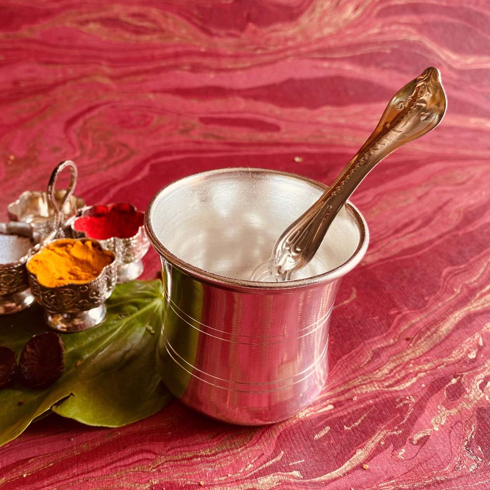 Silvery Panchapathiram with spoon for puja rituals and offerings.