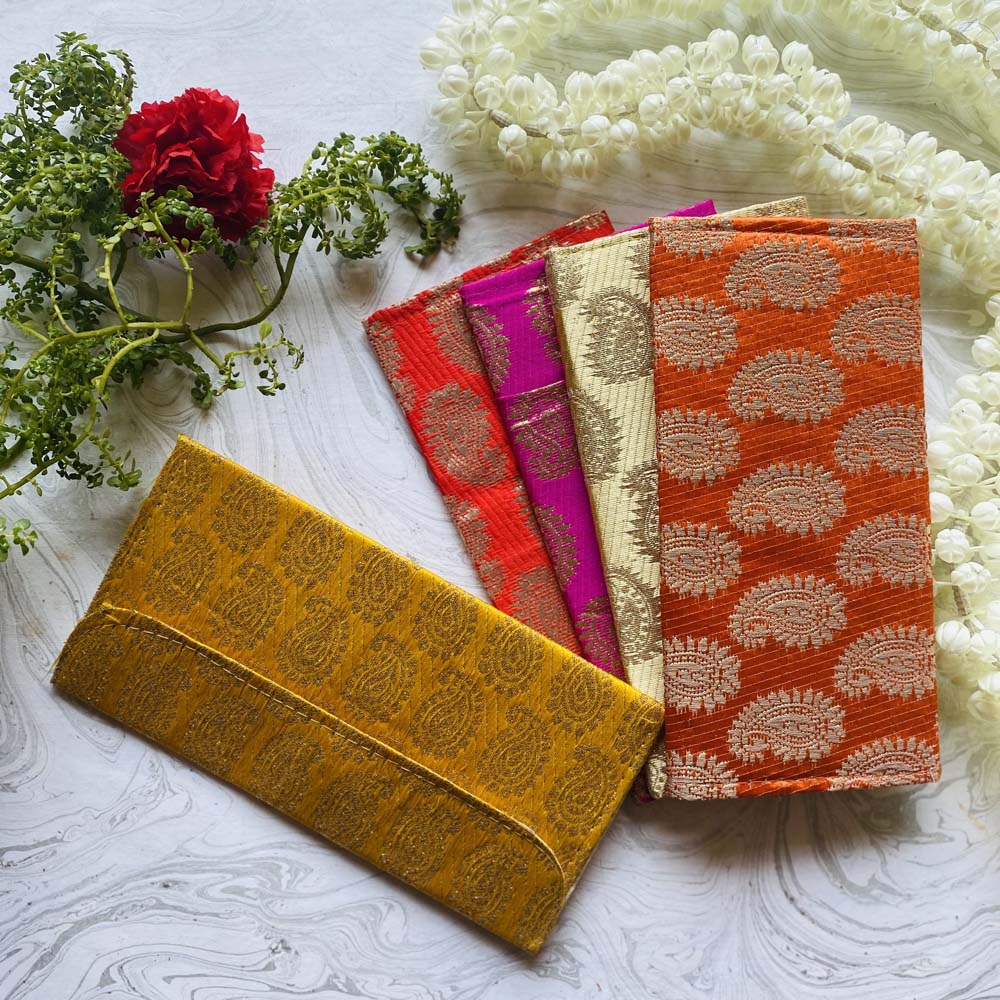 Set of five traditional money covers in vibrant colors with mango motifs and brocade texture, perfect for gifting during weddings and festivals.