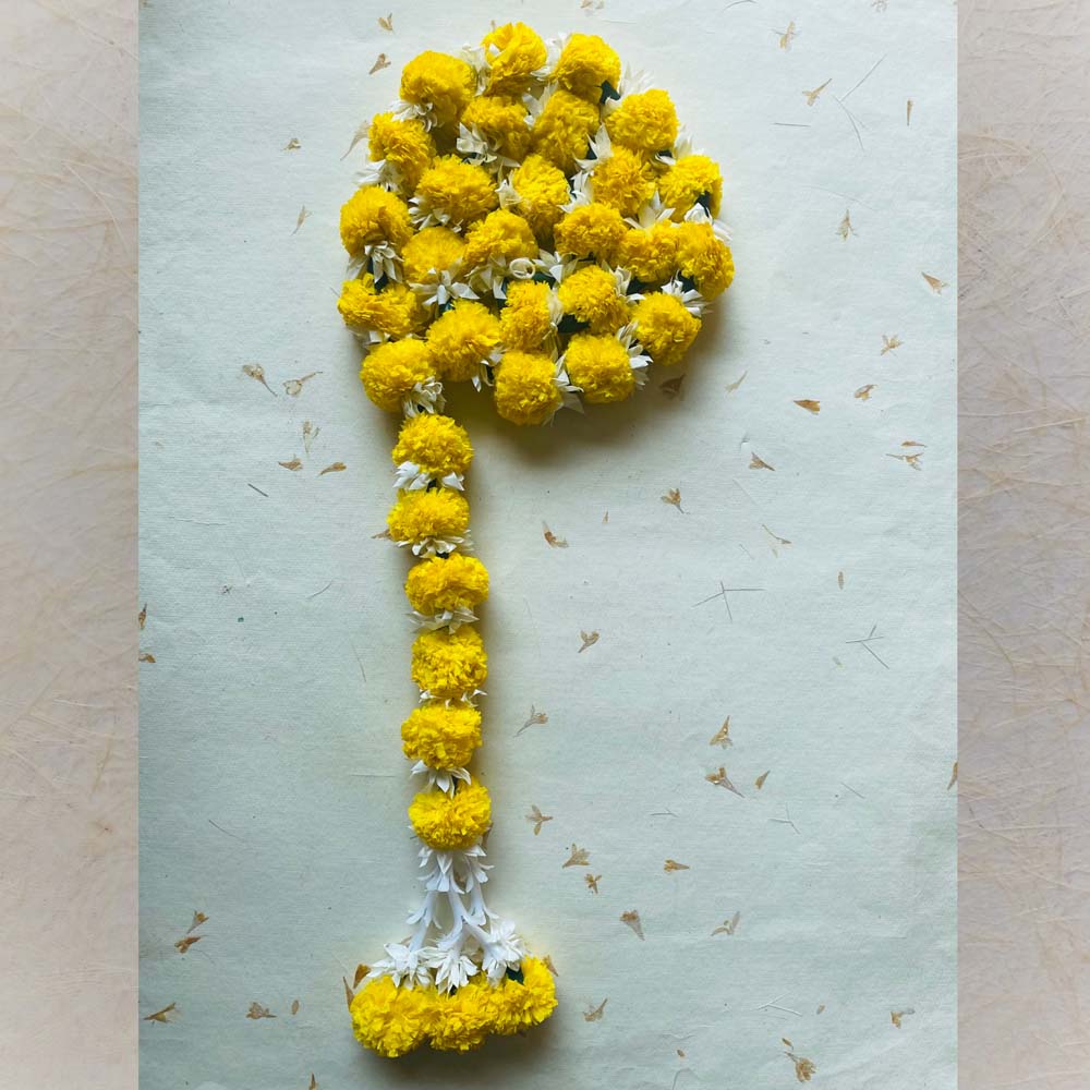 Yellow marigold single-string garland with white accents, perfect for traditional Indian decor and festive celebrations.
