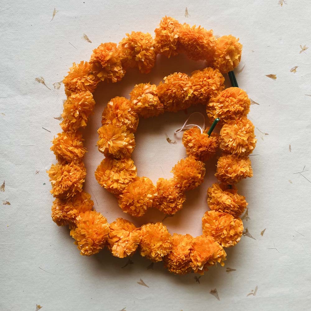 Handcrafted artificial flower garland in lemon and orange tones, perfect for temple and festive decorations.