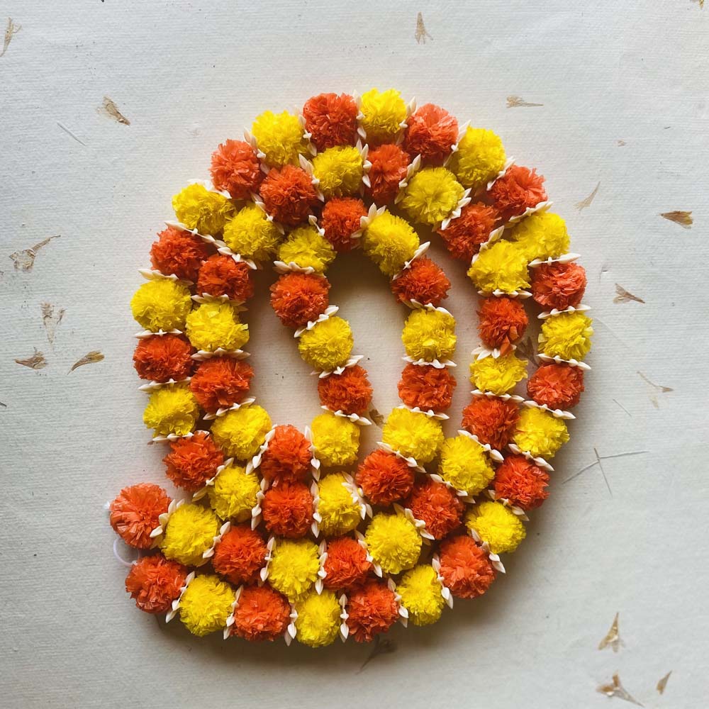 Small Laddu single-string garland with alternating orange and yellow flowers and white accents, ideal for festive and traditional Indian decor.