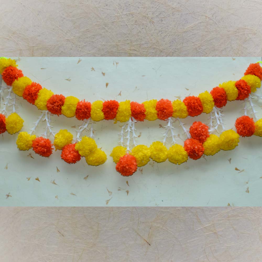 Thoranam garland with yellow and orange artificial flowers, cascading white details, and decorative jhumka accents for festive decor.
