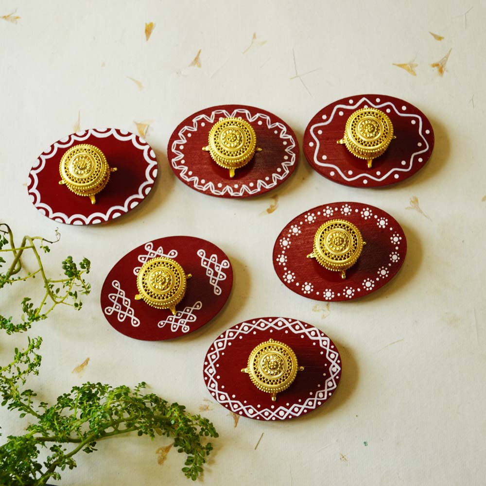 Set of handcrafted red Kollam Kumkum boxes with traditional white kolam patterns and golden accents, ideal for festive use.